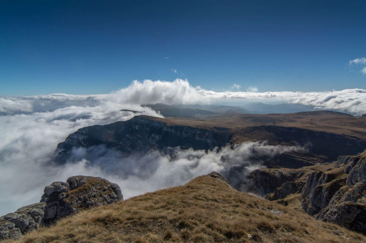 Munții Bucegi acoperiți de nori - fundal inspirațional pentru citate